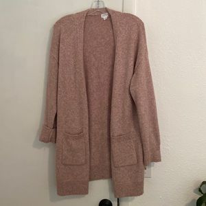 Pink stars above oversized cardigan